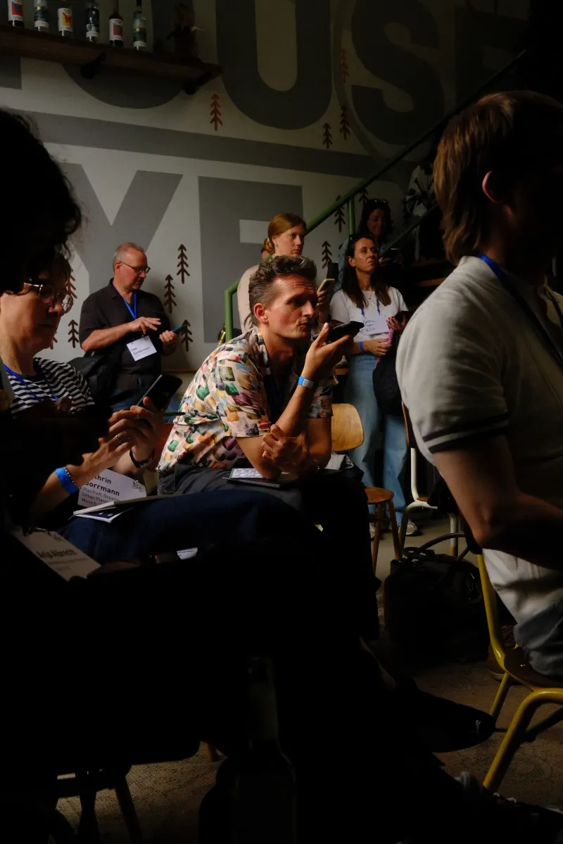 Workshop participant sharing thoughts by voice on a smartphone during a session